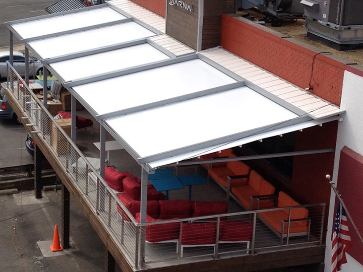 white awning pergola over a restaurant deck